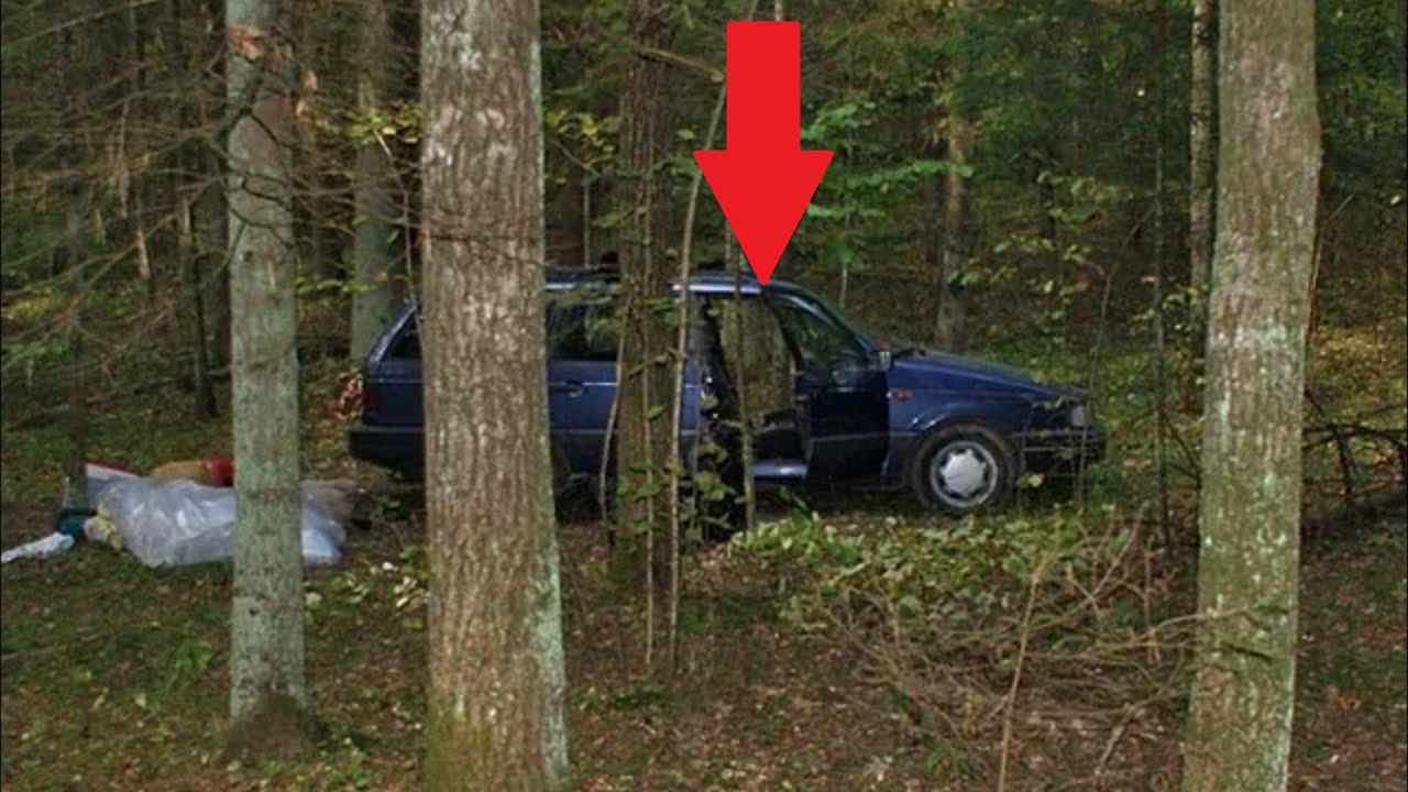 In the woods he finds an abandoned car, he looks inside and is speechless